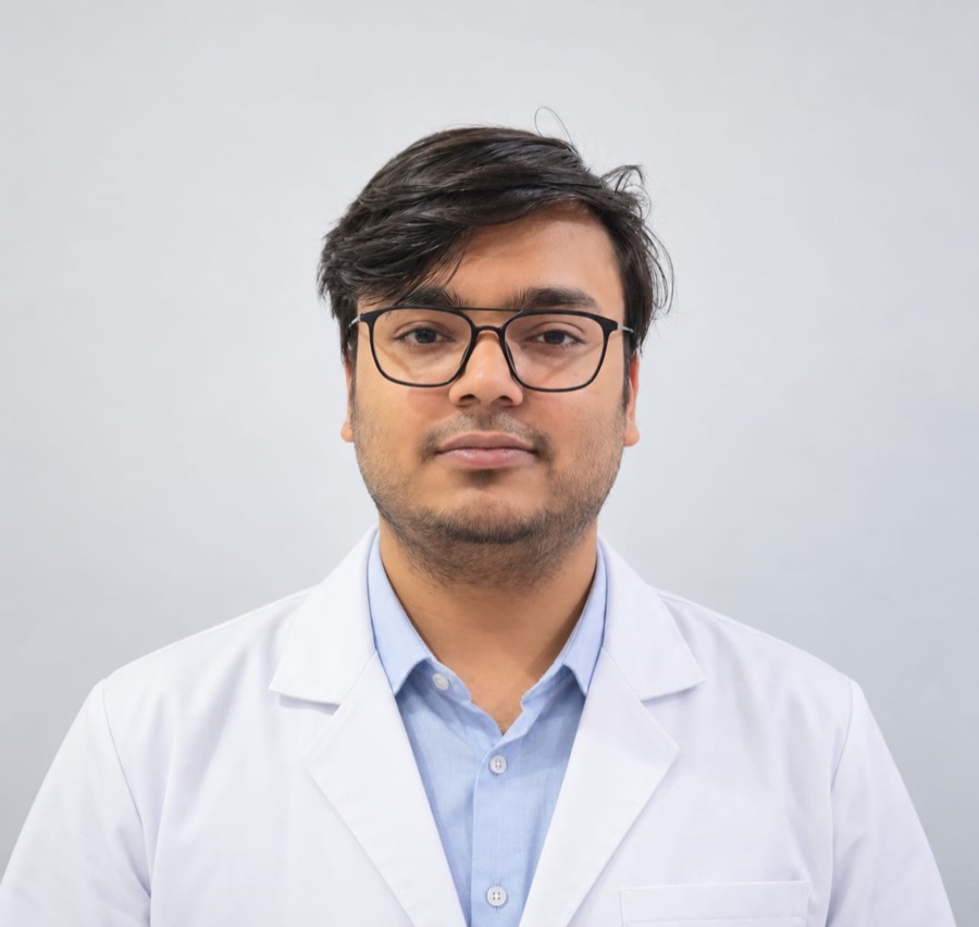 Portrait of Dr Kartikay Mishra in a white coat and glasses.